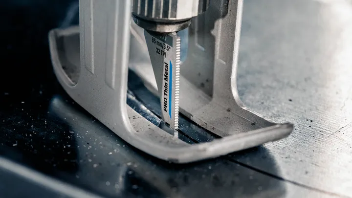 拼图锯在薄金属上切割出一条直线。