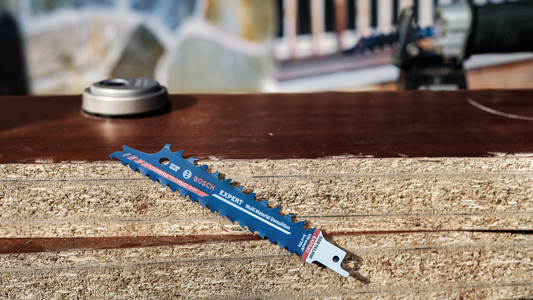 锯片放在室外的一堆木板上。.